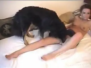 Skirt-wearing brunette banging her black dog