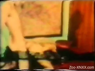 Retro zoo sex video featuring a curly-haired MILF and her dog