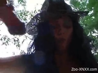 Latina in a snakeskin hat blows a hung horse