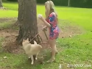 Playful blonde lady drinking dog's hot piss outdoors